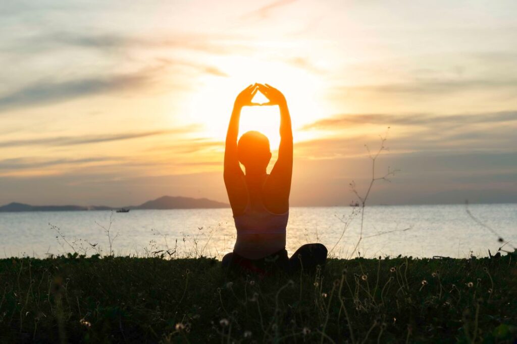 a woman meditating in nature