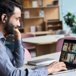 A business leader participates in a meeting using an AI assistant