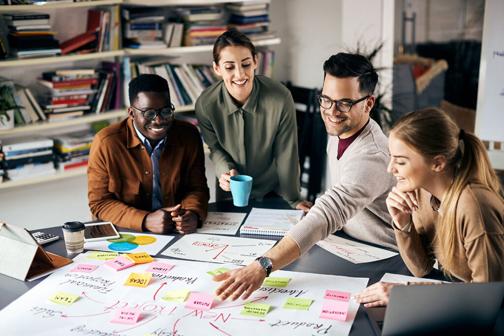 High angle view of young happy freelances brainstorming while working on new business