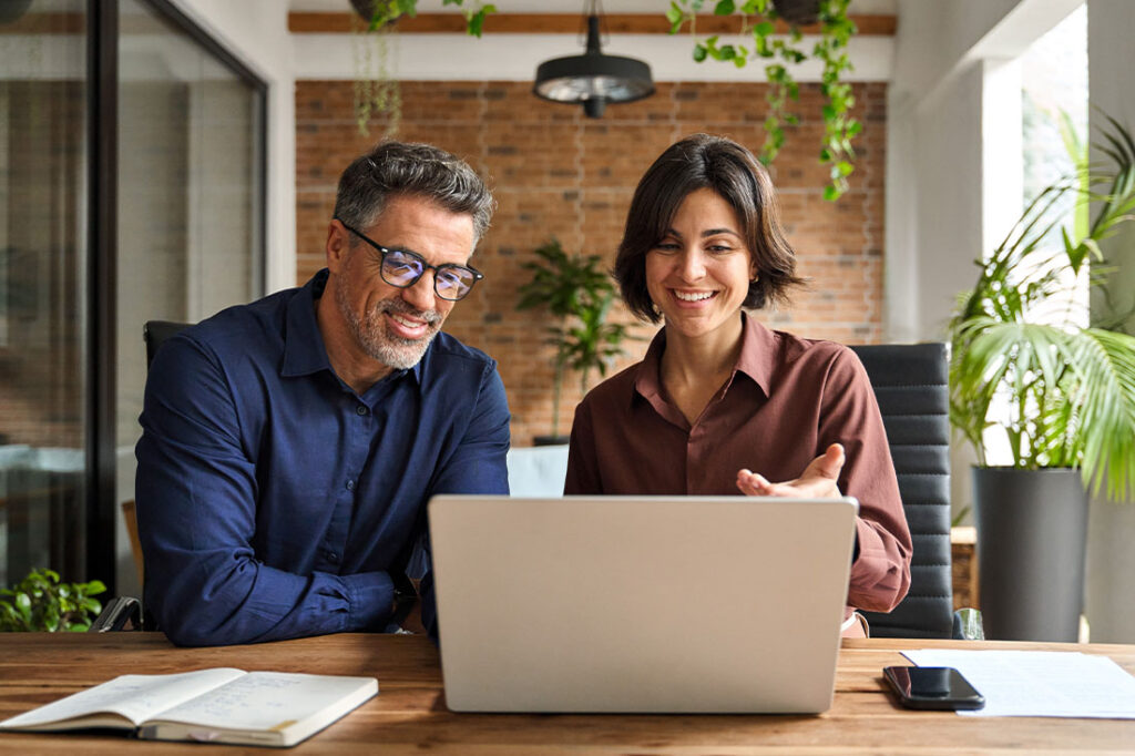 professional business man and woman executive leaders team using laptop working on computer at work