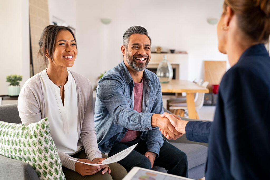 Woman shaking hands with happy clients