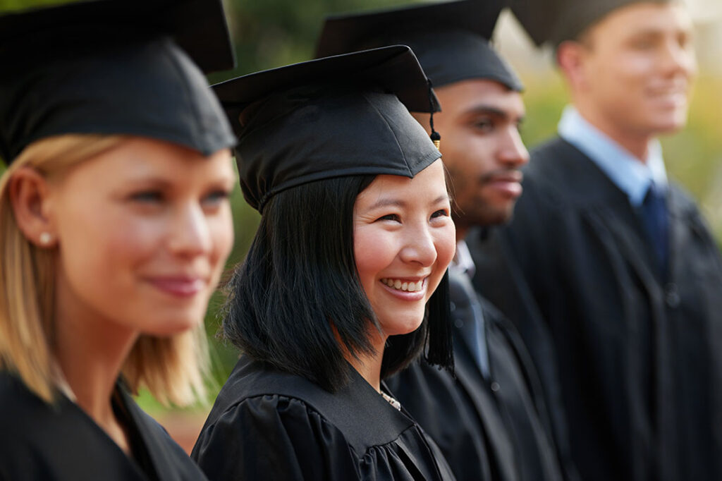student in row with friends for university or college ceremony