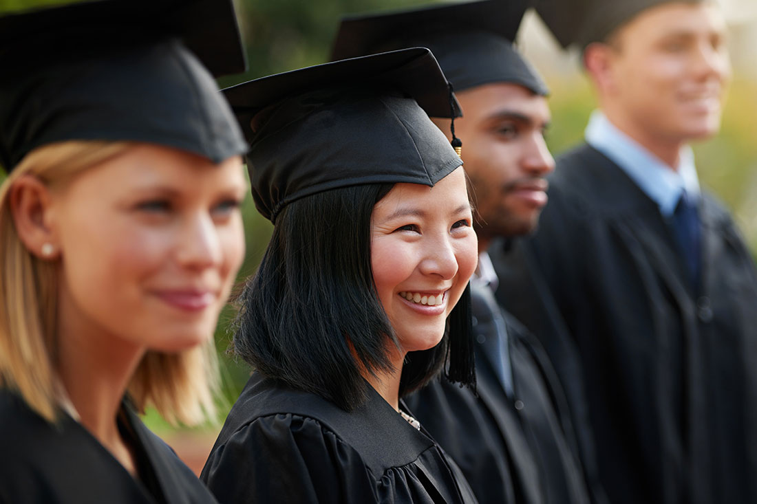 student in row with friends for university or college ceremony