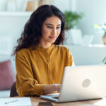 concentrated business woman working with laptop