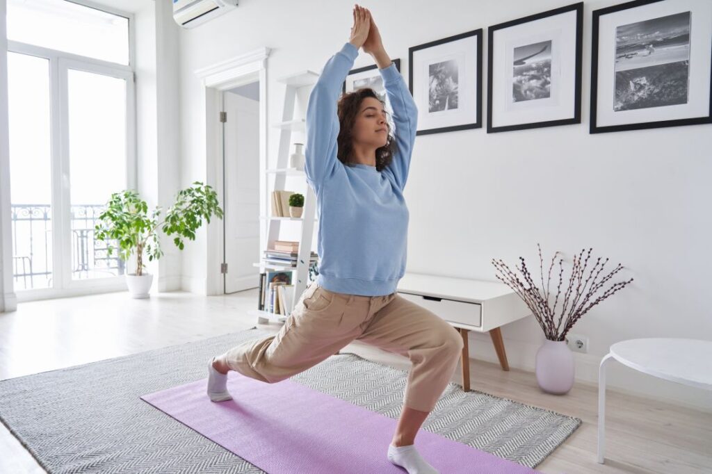 a woman doing yoga in her living room at home