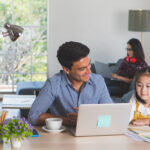 Two parents work from home with their child