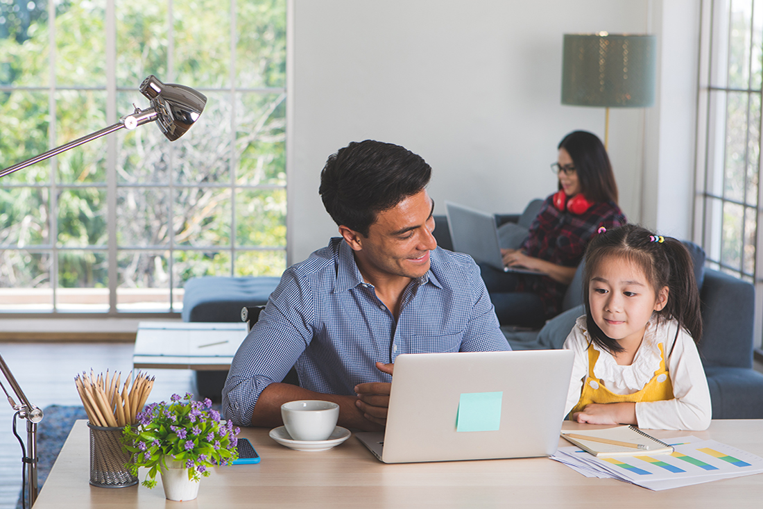 Two parents work from home with their child