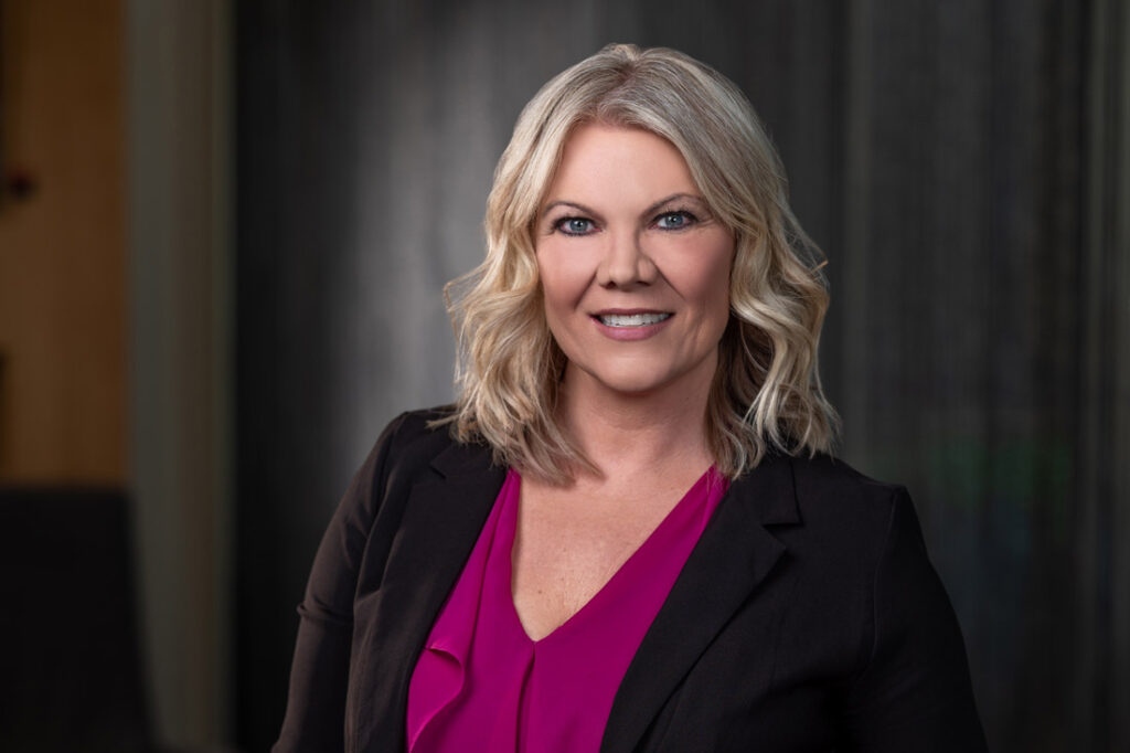 Kerrie Lee Brown SUCCESS Magazine's Editor in Chief, a white woman with shoulder length blond hair in business attire living with intention