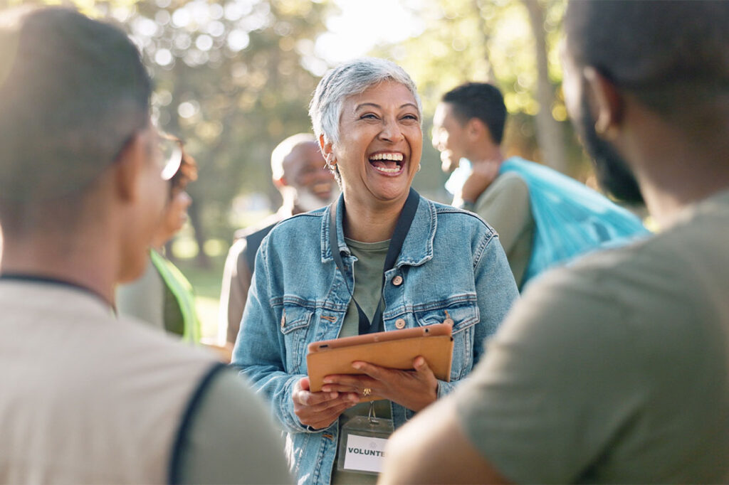 woman laughing planning with tablet for volunteer teamwork