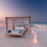 Bed set up by the concierge outside on the beach so guests can sleep under the stars at Milaidhoo Maldives
