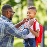 Father helping young son get ready for back to school with products that make it easier