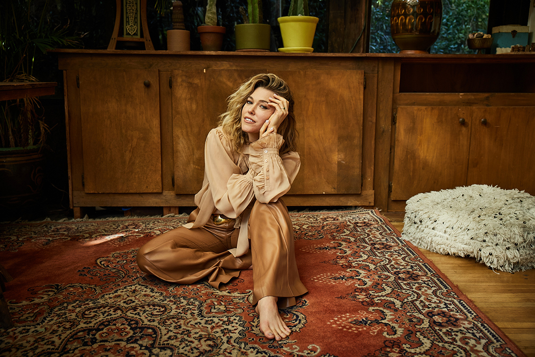 Rachel Platten poses in front of a brown dresser