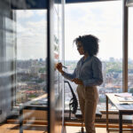 A woman plans out her plans for her second career on a whiteboard in an office building