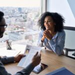 An HR director interviews a woman.