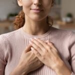 A woman with her hands over her heart