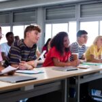 A group of students in the front row of a classroom.