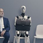 A man and a robot wait for a job interview.