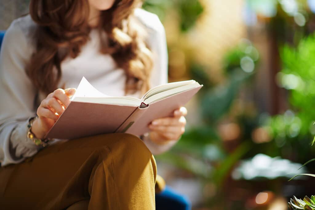 Woman reads book on sustainability