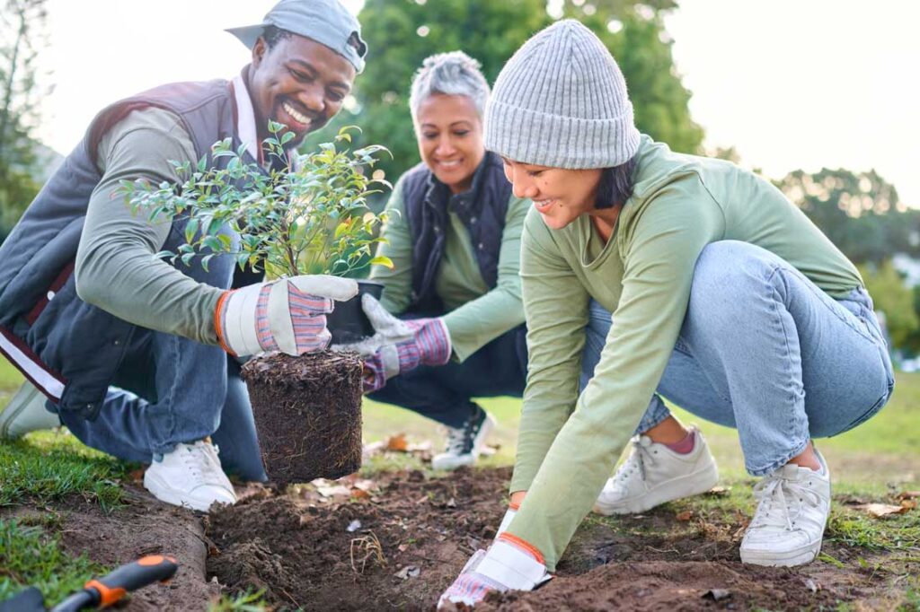 Group of people planting trees giving back to the community